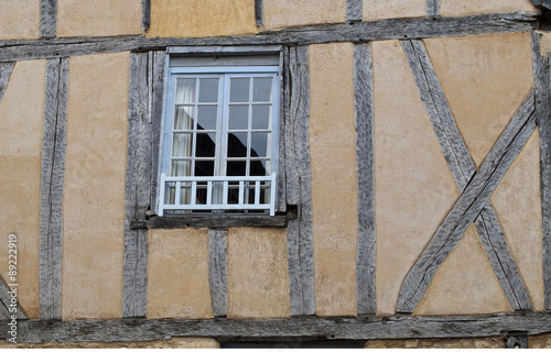 Historic old Building. An old medieval building built of wattle and daub has a window that is quite out of line with the building.