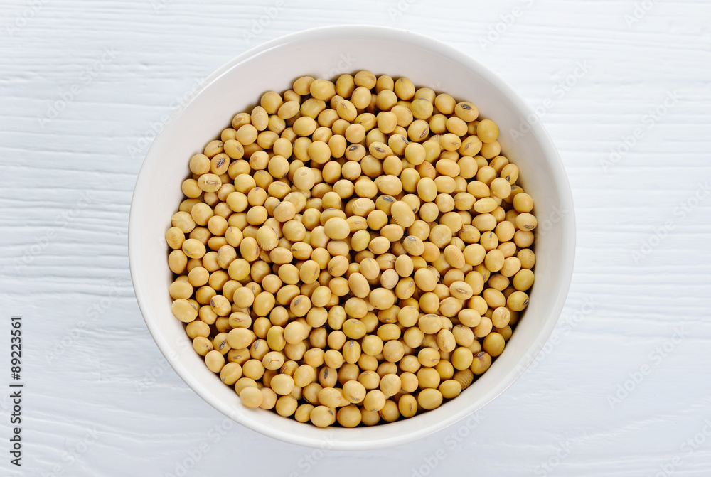 Soybeans in ceramic bowl on wood background. Soybeans in ceramic bowl on wood background.