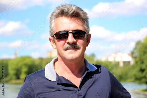 Portrait of handsome mature man. Handsome trendy mature man.  Middle age man in an outdoor setting. The man with the mustache © Agnes