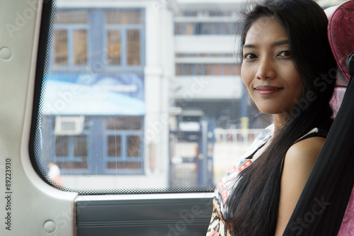 Young woman sitting in a double decker bus