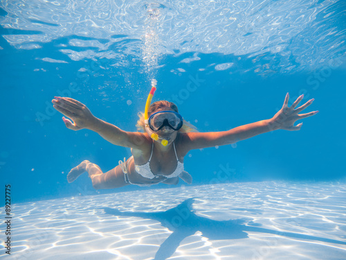 Woman wearing snorkeling mask swimming