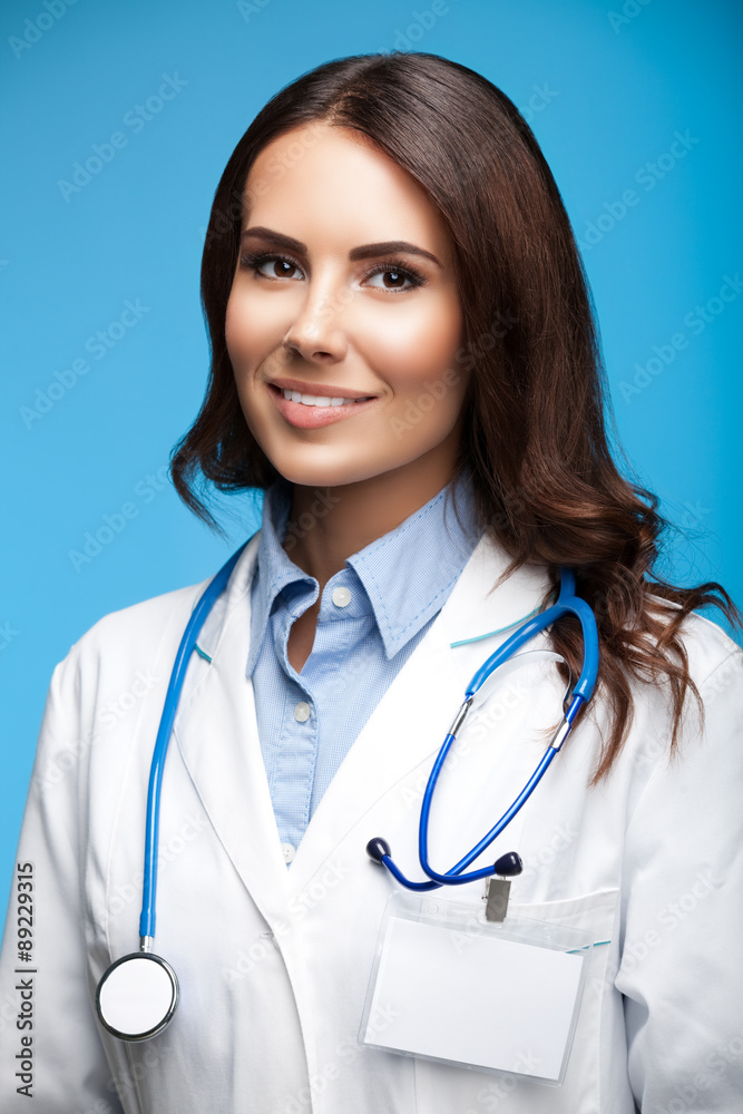 Doctor showing blank tablet pc with copyspace, on blue