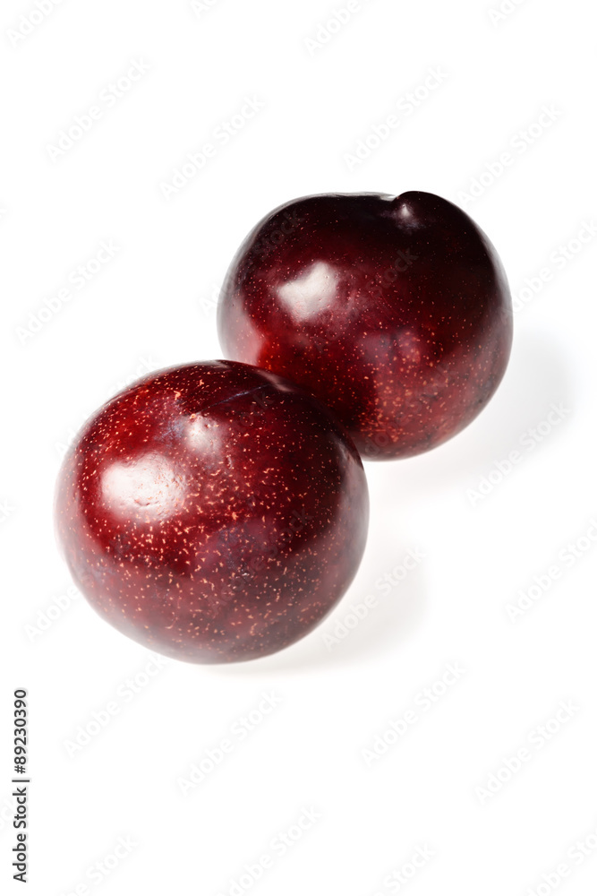 fresh black plums on white