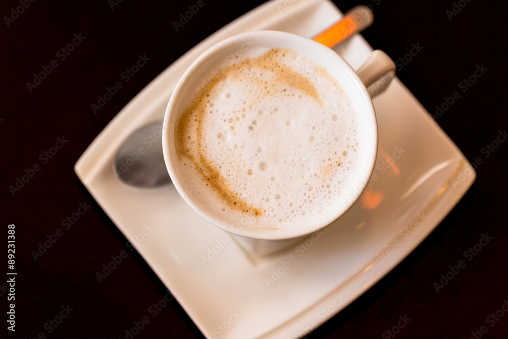 Top view of Hot coffee in white cup on black background Top view of Hot coffee in white cup on black background