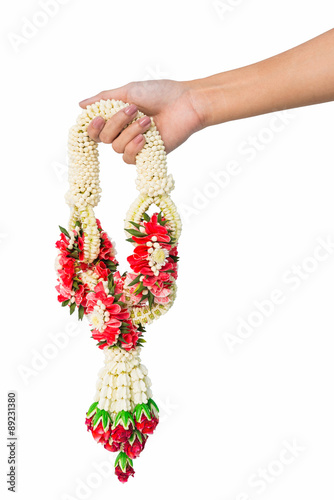 Asian woman's hand holding jasmine garland  isolated on white background