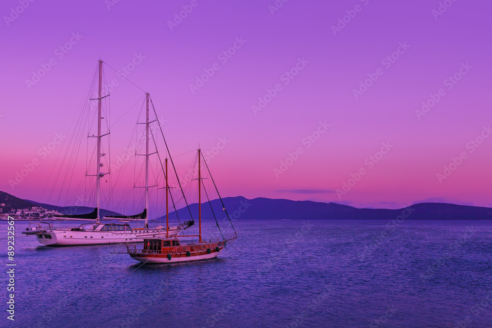Fototapeta premium Pink sunset at sea and two ships stand 