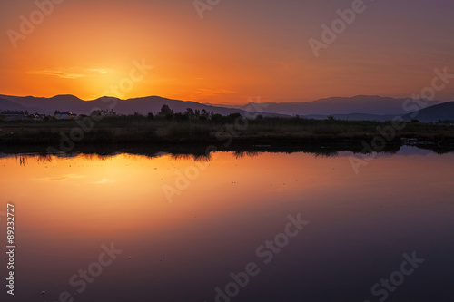 Beautiful Sunset on the sea, in the background mountains