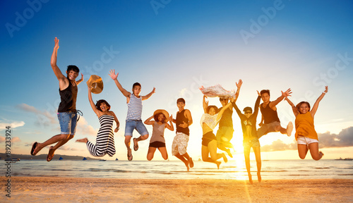 Group of friends jumping on beach
