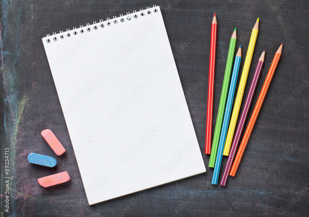 School supplies on blackboard background
