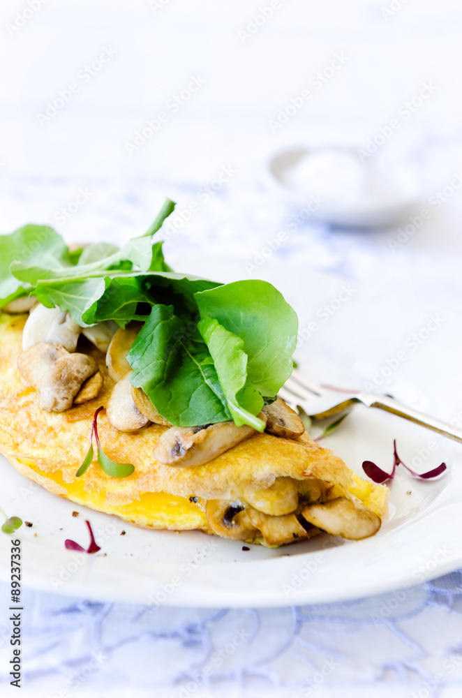 Omelette folded with mushrooms and fresh rocket