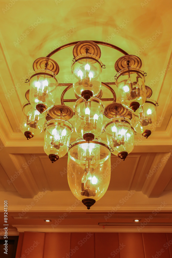 Yellow lamps with glass structure on ceiling in ballroom Yellow lamps with glass structure on ceiling in ballroom