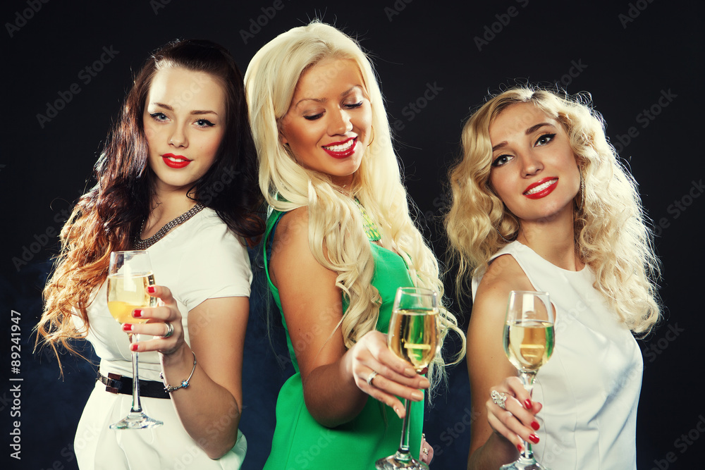 girls clinking flutes with sparkling wine