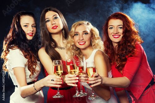 girls clinking flutes with sparkling wine