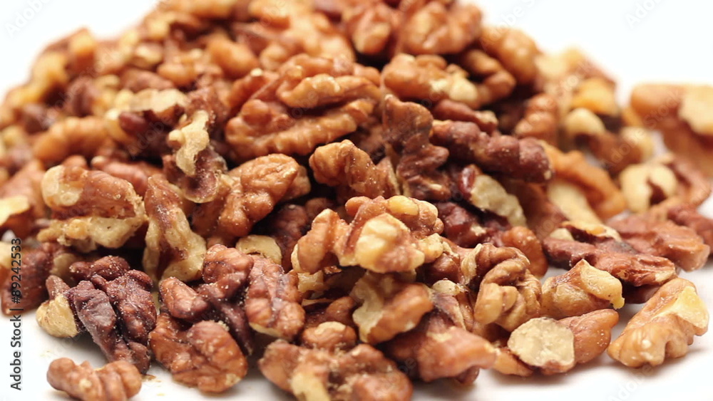 Heap of walnut kernels isolated on white, rotating Heap of walnut kernels isolated on white, rotating