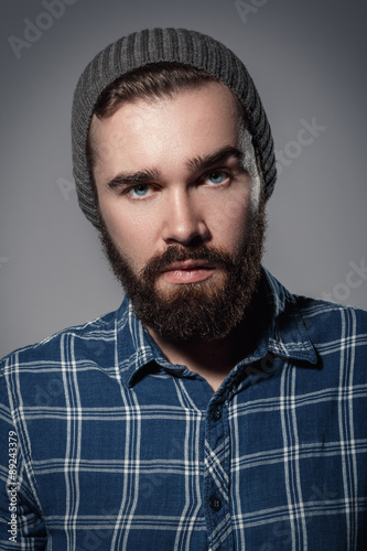 Handsome bearded man in checkered shirt