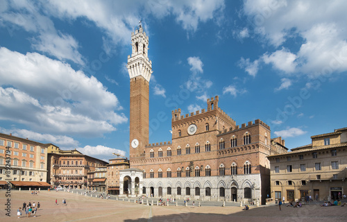 SIENA, ITALY - June 13, 2015: tourists enjoy Piazza del Campo square in Siena, Italy. © nexusseven