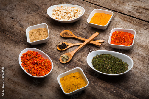 Fototapeta Naklejka Na Ścianę i Meble -  Colorful spices on rustic wooden table