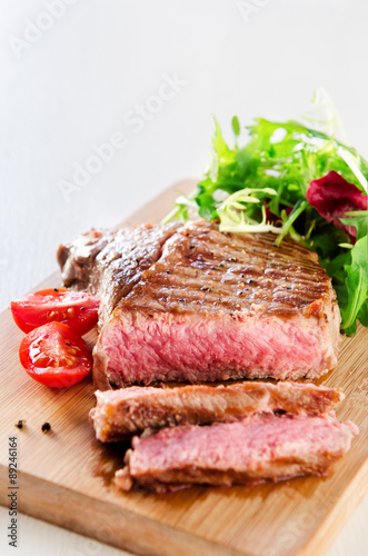 Grilled ribeye steak served with healthy salad