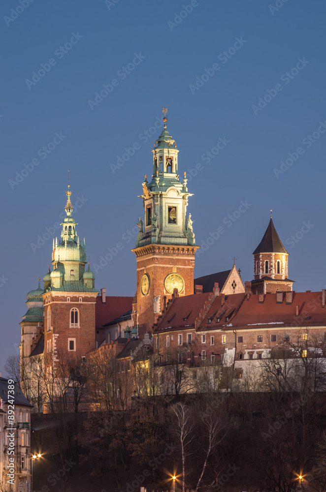 Sigismund, Clock and Silver Bells towers of the St Stanislaw and St Vaclav cathedral on the Wawel Hill with the fortifications of the Wawel castle in the night