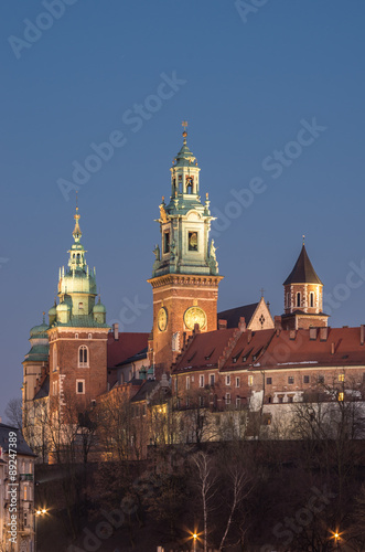 Sigismund, Clock and Silver Bells towers of the St Stanislaw and St Vaclav cathedral on the Wawel Hill with the fortifications of the Wawel castle in the night #89247389