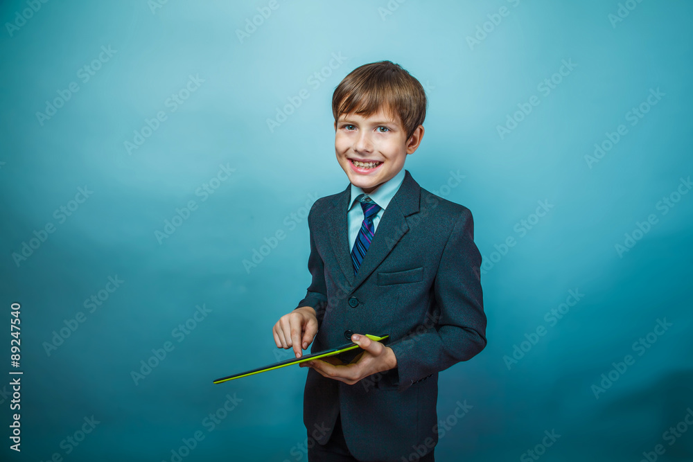 teenager boy dressed businessman holding a tablet Photo Studio teenager boy dressed businessman holding a tablet Photo Studio
