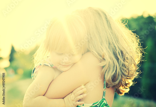 Obraz na płótnie Two sisters Cuddled up together. Back lighting sunlight. w salonie