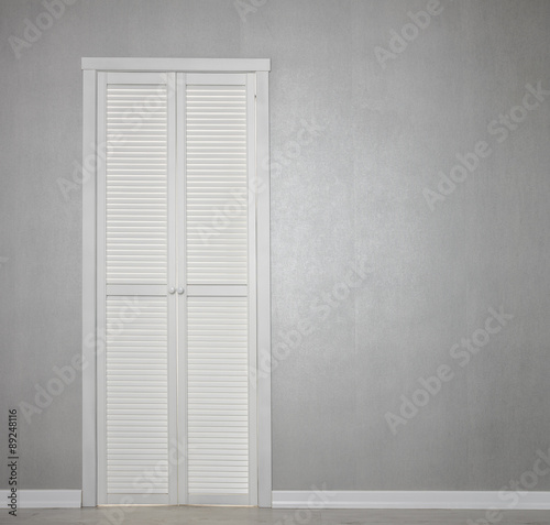 Closed White Door on grey Wall
