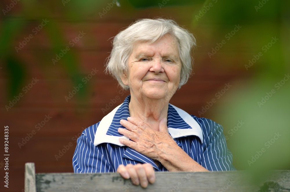 Senior woman smiling and dreaming in garden. Senior woman smiling and dreaming in garden.