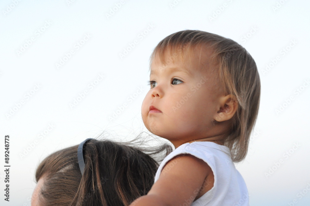 Baby girl portrait on father's neck