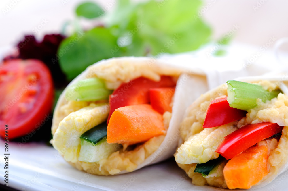Healthy bite size wraps with carrot, capsicum and a side salad Healthy bite size wraps with carrot, capsicum and a side salad