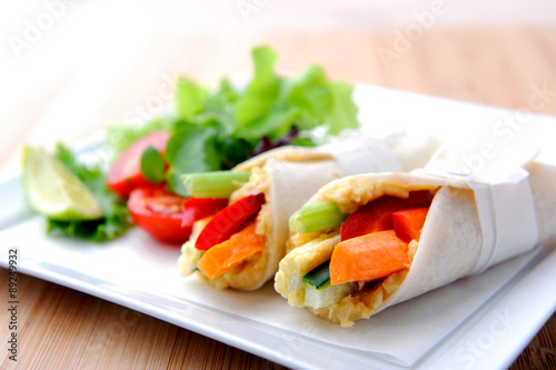 Healthy bite size wraps with carrot, capsicum and a side salad © Daxiao Productions