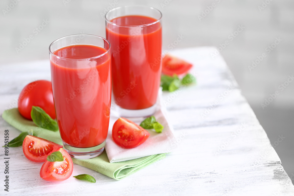Tomato juice and fresh tomatoes on wooden table close-up Tomato juice and fresh tomatoes on wooden table close-up