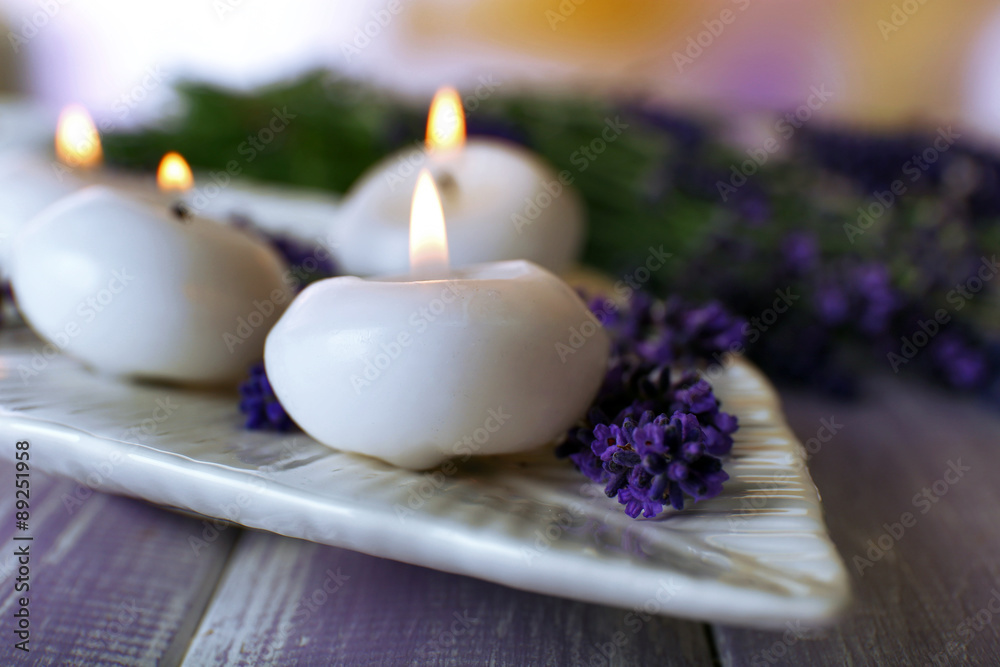 Candles with lavender flowers on table close up Candles with lavender flowers on table close up