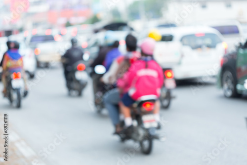car and motorcycle driving on road with traffic jam in the city, abstract blurred © sutichak