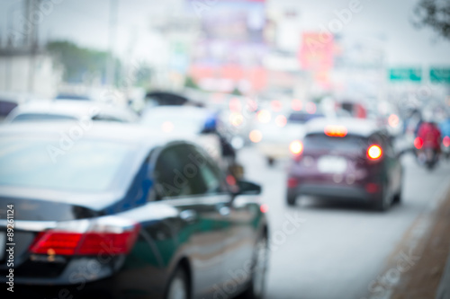 car driving on road with traffic jam in the city, abstract blurred