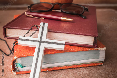 The cross against the book.