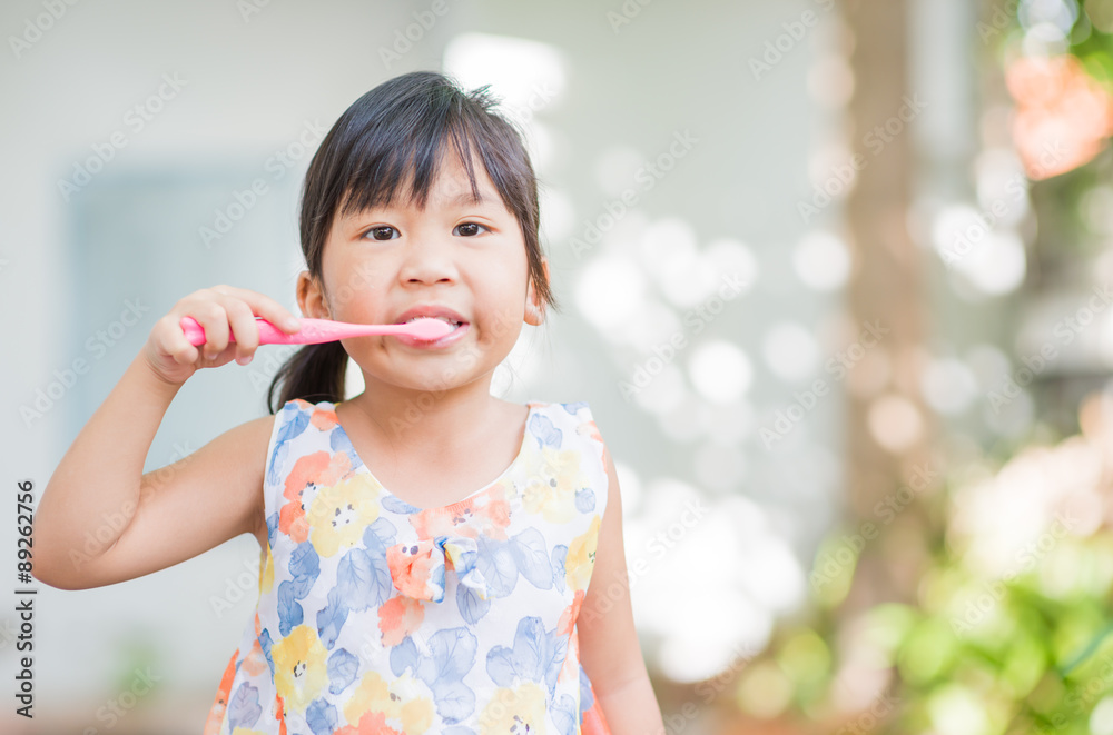 dental hygiene. happy little asian girl brushing her teeth dental hygiene. happy little asian girl brushing her teeth