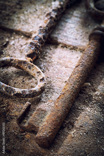 Old rusty keys on a wooden table
