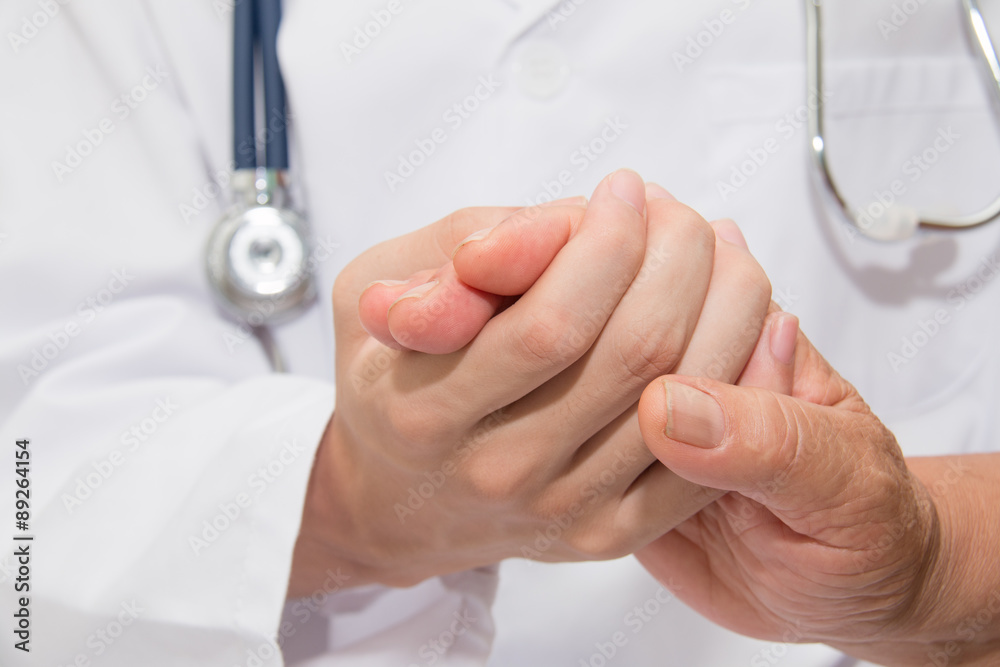 Doctor holding an old woman's hand Doctor holding an old woman's hand