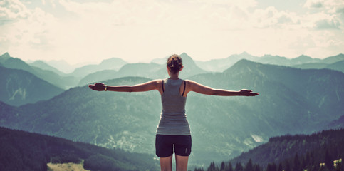Woman celebrating nature and reaching the summit