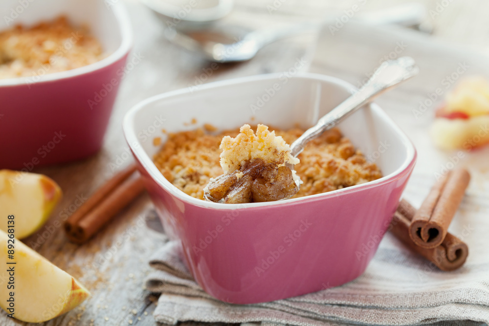 Apple crumble with cinnamon on rustic wooden table Apple crumble with cinnamon on rustic wooden table
