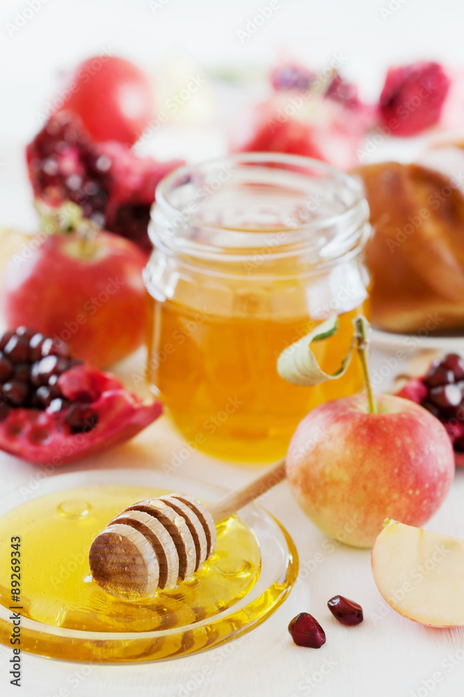 Honey, apple, pomegranate and hala, table set with traditional food for Jewish New Year Holiday, Rosh Hashana Honey, apple, pomegranate and hala, table set with traditional food for Jewish New Year Holiday, Rosh Hashana