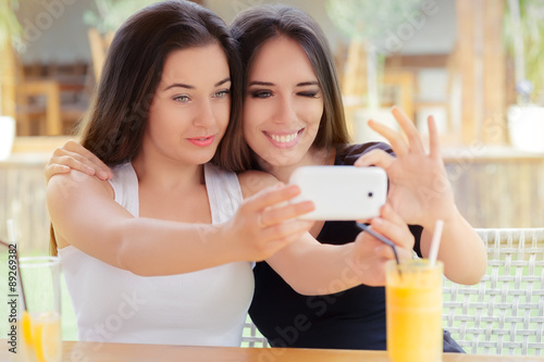 Happy Girls Taking a Selfie Together photo