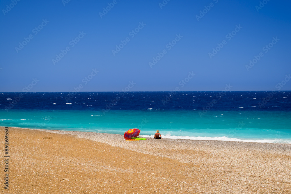 Solitary sunbather at the North tip of Rhodes Solitary sunbather at the North tip of Rhodes