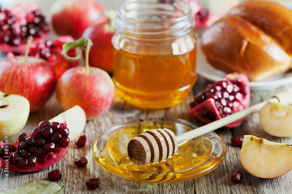 Honey, apple, pomegranate and hala, table set with traditional food for Jewish New Year Holiday, Rosh Hashana Honey, apple, pomegranate and hala, table set with traditional food for Jewish New Year Holiday, Rosh Hashana