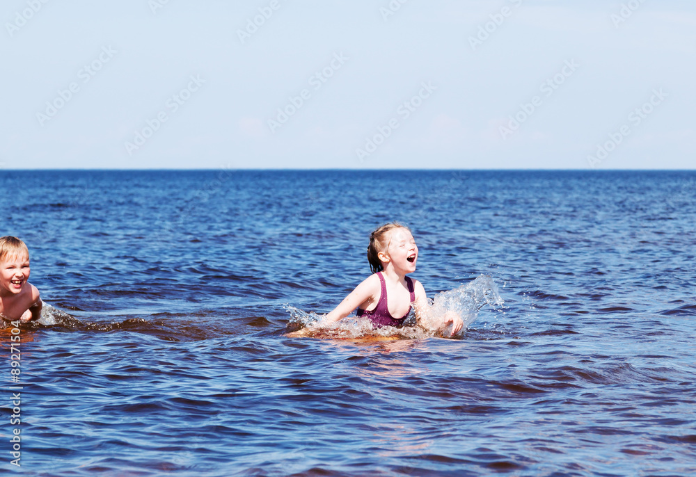 Girl and boy swimming in the lake