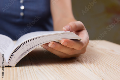 Closeup hand open book for reading concept background