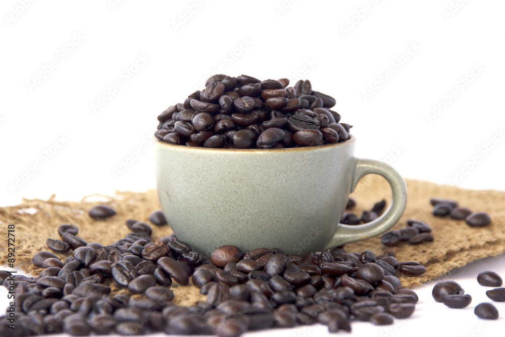 Fototapeta premium Stock Photo:.Cup full of coffee beans on the cloth sack