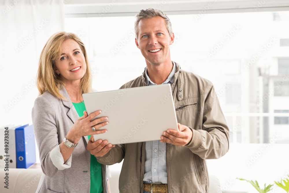 Smiling casual business colleagues with laptop Smiling casual business colleagues with laptop