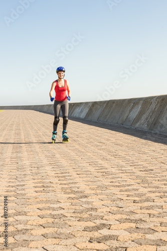 Smiling sporty blonde skating